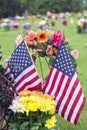 Two American flag and Flowers on veteran Graveside