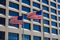 Two American Flags fly in the breeze in front of a building in Lower Manhattan, NYC Royalty Free Stock Photo