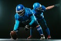 Two American football players are ready to start the game on a black background. Royalty Free Stock Photo