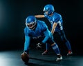 Two American football players are ready to start the game on a black background. Royalty Free Stock Photo