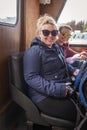 Two American women tourists sitting inside on the Spirit Island boat cruise on Maligne Lake smiling and enjoying the ride, focus Royalty Free Stock Photo