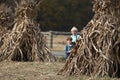 Two Amish boys playing by corn shocks