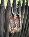 Two ancient bast shoes on the wooden fence