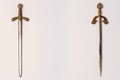 Two ancient knightly swords with golden hilts with engraving isolated on a white background Royalty Free Stock Photo