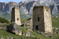 Two ancient Ossetian defensive towers against the backdrop of the Caucasus mountains