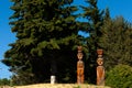 Two ancient wooden Indian statues on a mountain among trees and pine trees South America, Bariloche Royalty Free Stock Photo