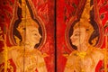 Two angel guardians image painting on the wooden door in the temple of Bangkok, Thailand, the art of painting in Thai style Royalty Free Stock Photo