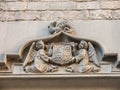 Two angels hold an ancient shield of Barcelona, which contains Masonic symbols, on a dragon. Door of the Convent of San AgustÃÂ­n