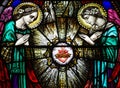 Two angels with the sacred heart in stained glass