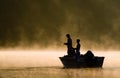 Two Anglers Fishing On A Lake