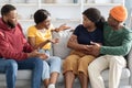 Two angry black girlfriends fighting while having double date Royalty Free Stock Photo