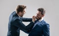 two angry businessmen punching in fight and arguing having struggle for leadership, confrontation. Royalty Free Stock Photo