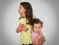 Two angry sisters standing back to back Royalty Free Stock Photo