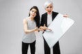 Two angry girls holding an empty poster isolated on white background