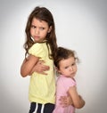 Two angry sisters standing back to back Royalty Free Stock Photo