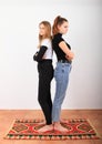 Two angry teenage girls standing on oriental carpet Royalty Free Stock Photo