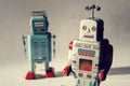 Two vintage tin toy robots, robotic delivery, artificial intelligence concept Royalty Free Stock Photo