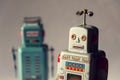 Two vintage tin toy robots, robotic delivery, artificial intelligence concept Royalty Free Stock Photo