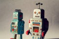 Two angry vintage tin toy robots, artificial intelligence, robotic drone delivery, machine learning concept Royalty Free Stock Photo