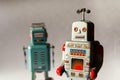 Two angry vintage tin toy robots, artificial intelligence, robotic drone delivery, machine learning concept Royalty Free Stock Photo