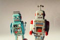 Two angry vintage tin toy robots, artificial intelligence, robotic drone delivery, machine learning concept