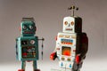 Two angry vintage tin toy robots, artificial intelligence, robotic drone delivery, machine learning concept Royalty Free Stock Photo