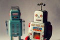 Two angry vintage tin toy robots, artificial intelligence, robotic drone delivery, machine learning concept Royalty Free Stock Photo