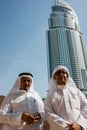 Two anonymous Arab men in traditional white clothing