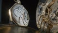 Two antique gold pocket watches with clockwork on isolated black studio background. Close up gears inside old mechanic Royalty Free Stock Photo