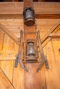 Two antique rusty lanterns hang from a farmhouse wall