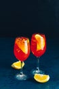 Two Aperol spritz cocktail in big wine glass with oranges, summer Italian fresh alcohol cold drink