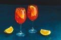 Two Aperol spritz cocktail in big wine glass with oranges, summer Italian fresh alcohol cold drink