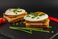 Delicious breakfast sandwiches with eggs, cheese, and ham on slate Royalty Free Stock Photo