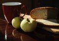 Two apples and bread on a board and red cup Royalty Free Stock Photo