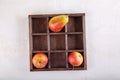 Two apples and one pear in wooden box on white background. Tic tac toe game. Top view. Copy space Royalty Free Stock Photo