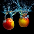 Two apples in water on a black background.red apple dropped into water with splash isolated on black Royalty Free Stock Photo