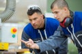 two apprentices checking pipes Royalty Free Stock Photo