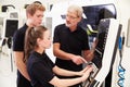 Two Apprentices Working With Engineer On CNC Machinery Royalty Free Stock Photo