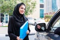 Two Arab Business Women Discussing next to a car