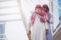 Two Arab businessmen Greet with a hug, on city