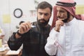 Two arab men working in office. Coworkers are taking notes on glass board. Royalty Free Stock Photo