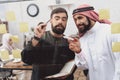 Two arab men working in office. Coworkers are taking notes on glass board. Royalty Free Stock Photo