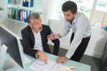 Two architects discussing blueprints in office Royalty Free Stock Photo