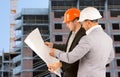 Two architects discussing a building blueprint Royalty Free Stock Photo