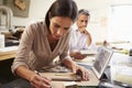 Two Architects Making Models In Office Using Digital Tablet