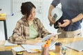 Two architects in office discussing layout of building together on digital tablet Royalty Free Stock Photo