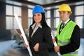 Two architects with plans in hand Royalty Free Stock Photo