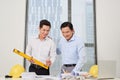 Two architects standing at a desk and discussing a project Royalty Free Stock Photo