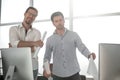 Two architects talk while standing in a design office Royalty Free Stock Photo