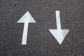 Two arrows on asphalt. Sign of two-way street.